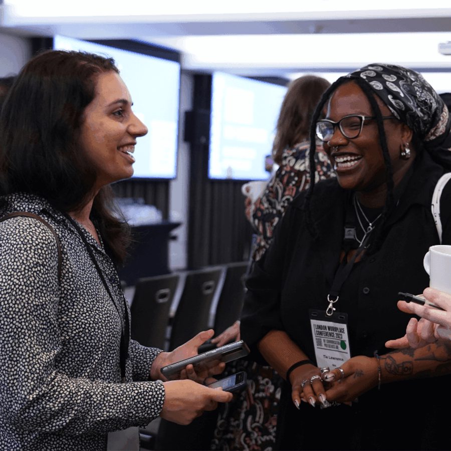 Three people talking at a conference square crop